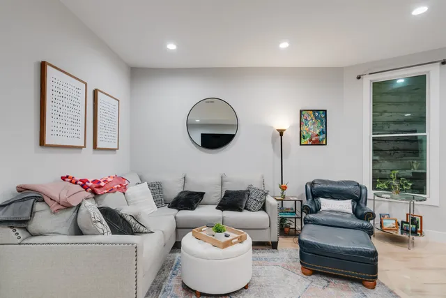 a living room with furniture and a large window