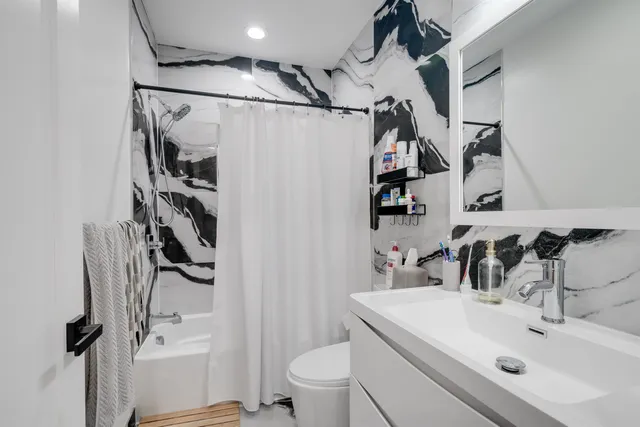 a bathroom with a sink toilet and shower