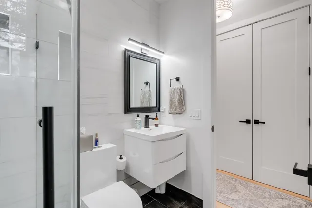 a bathroom with a sink mirror toilet and shower