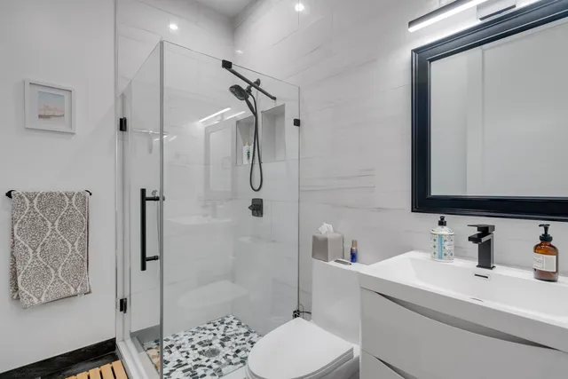 a bathroom with a sink toilet and shower