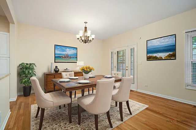 a view of a dining room with furniture wooden floor and a chandelier