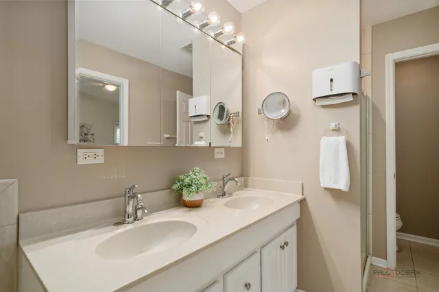 a bathroom with a sink vanity and a mirror