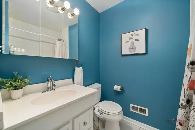 a bathroom with a sink toilet and a mirror