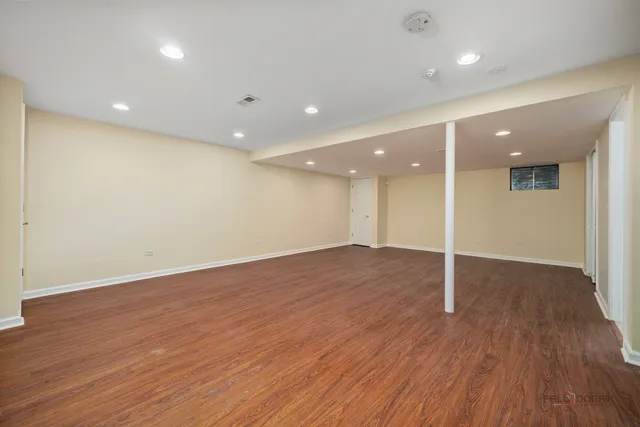 an empty room with wooden floor