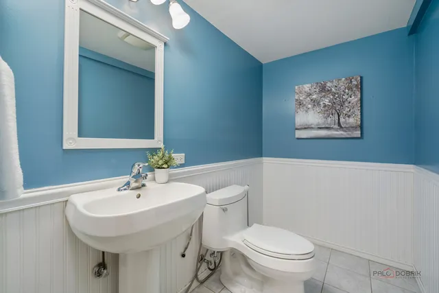 a bathroom with a toilet a sink and mirror