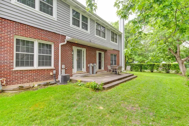 a front view of house with yard and outdoor seating