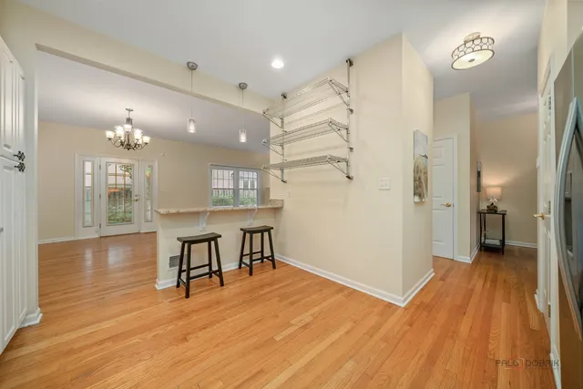 a view of a livingroom with a furniture wooden floor and a kitchen
