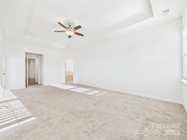 a view of a livingroom with a ceiling fan and window