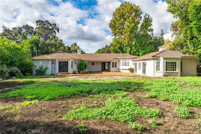 a front view of house with yard and green space