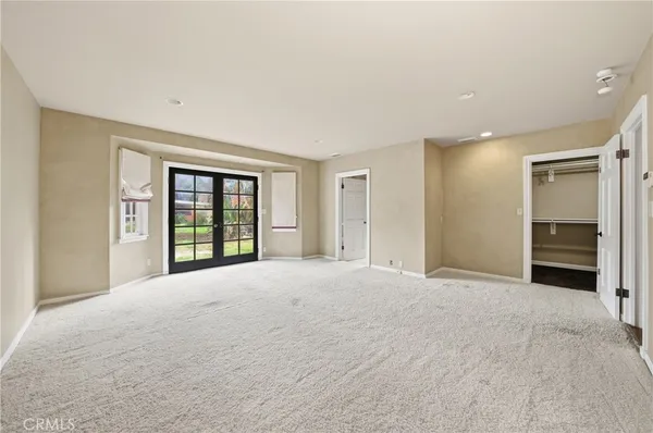 a large kitchen with a lot of counter space and wooden floor