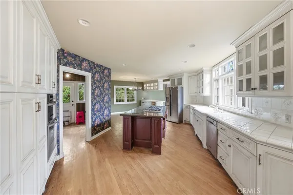 a spacious bathroom with a granite countertop double vanity sink a mirror and a window