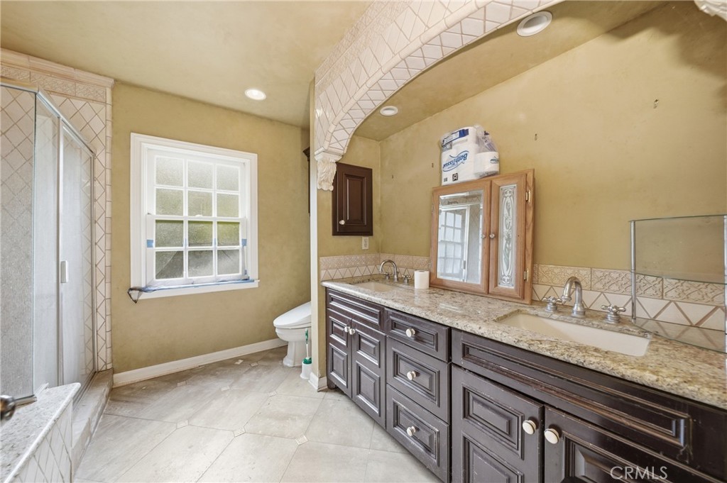 1210 Rodeo Road Arcadia, CA 91006 - Photo 16 of 45 a spacious bathroom with a granite countertop double vanity sink a mirror and a window