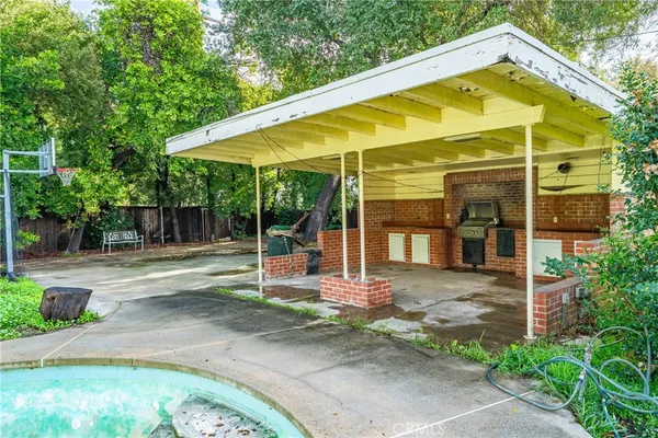 a view of backyard with swimming pool