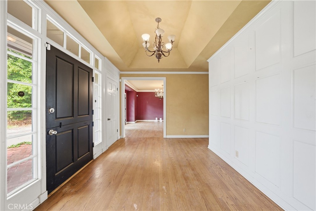 1210 Rodeo Road Arcadia, CA 91006 - Photo 22 of 45 a view of hallway with chandelier and wooden floor