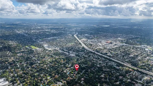 a view of a house with a big yard and large trees