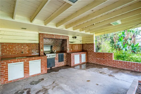 a view of a porch with furniture and a backyard