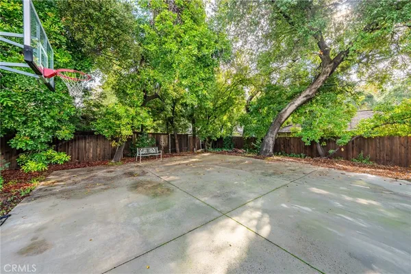 a view of a backyard with large trees