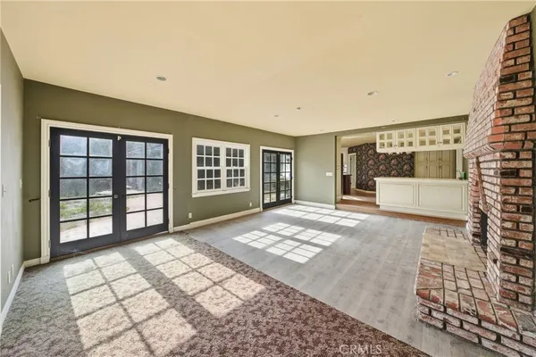a kitchen with stainless steel appliances granite countertop a stove a refrigerator and a sink with wooden cabinets