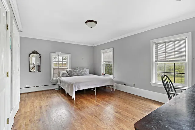 a living room with hardwood floor and a window
