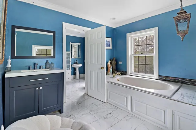 a spacious bathroom with a sink and a bathtub