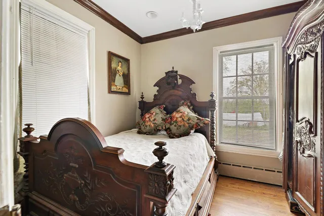 a bed sitting in a bedroom next to a window