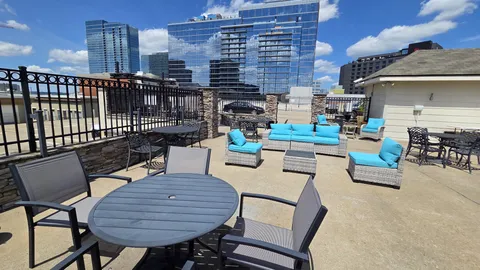 a view of a roof deck with couches table and chairs