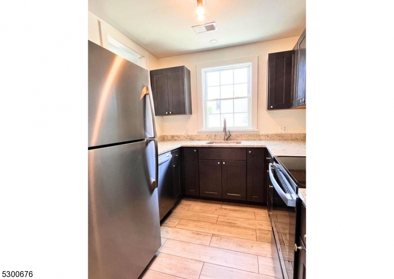 1 North Main Street, Unit 2 Stockton, NJ 08559 - Photo 8 of 12 a kitchen with a sink and a refrigerator