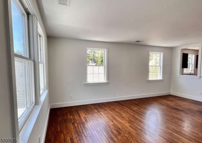 1 North Main Street, Unit 2 Stockton, NJ 08559 - Photo 9 of 12 an empty room with wooden floor and windows