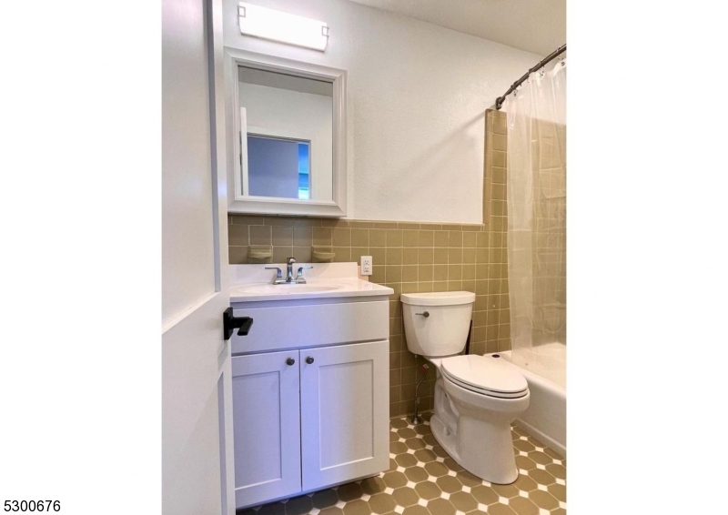 1 North Main Street, Unit 2 Stockton, NJ 08559 - Photo 10 of 12 a bathroom with a sink toilet and mirror