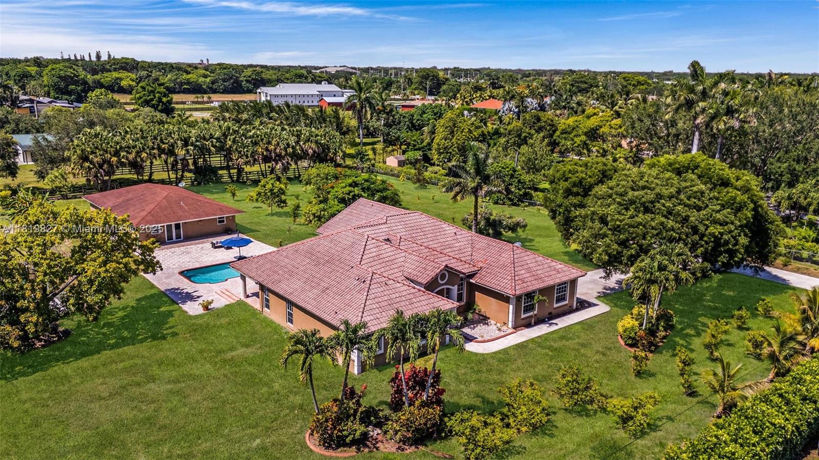 12851 Luray Road Southwest Ranches, FL 33330 - Photo 1 of 58 an aerial view of a house with a garden