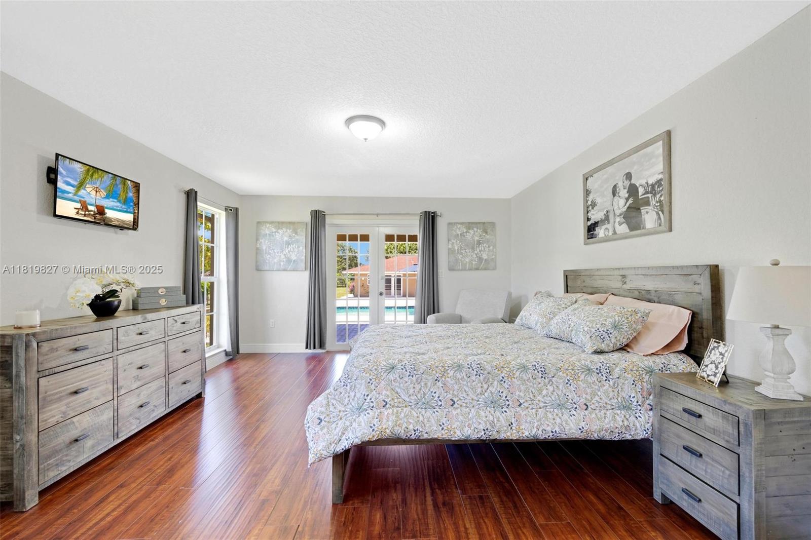 12851 Luray Road Southwest Ranches, FL 33330 - Photo 12 of 58 a bedroom with a bed and a dresser with wooden floor