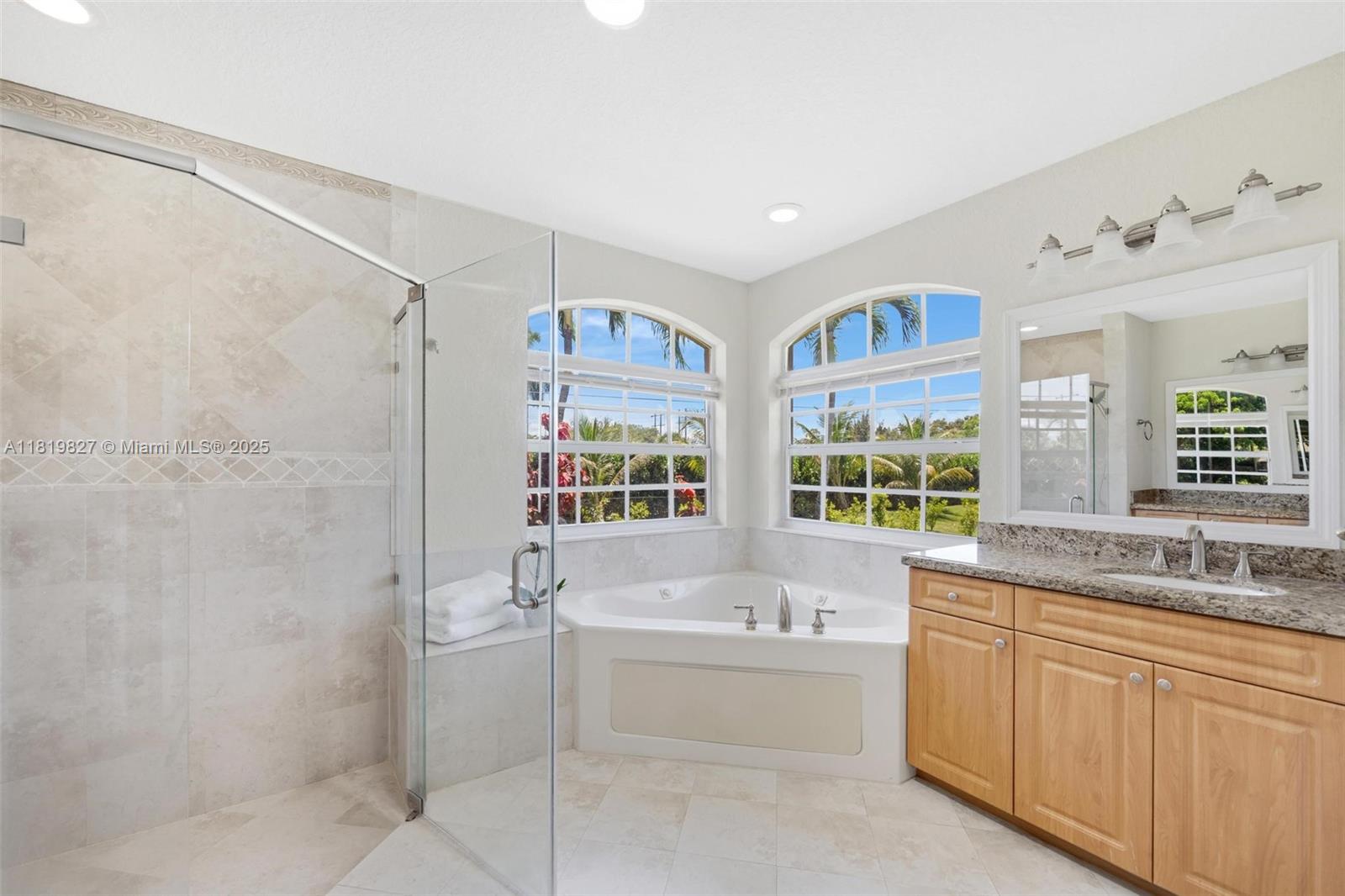 12851 Luray Road Southwest Ranches, FL 33330 - Photo 14 of 58 a bathroom with a granite countertop sink mirror bathtub and next to a window