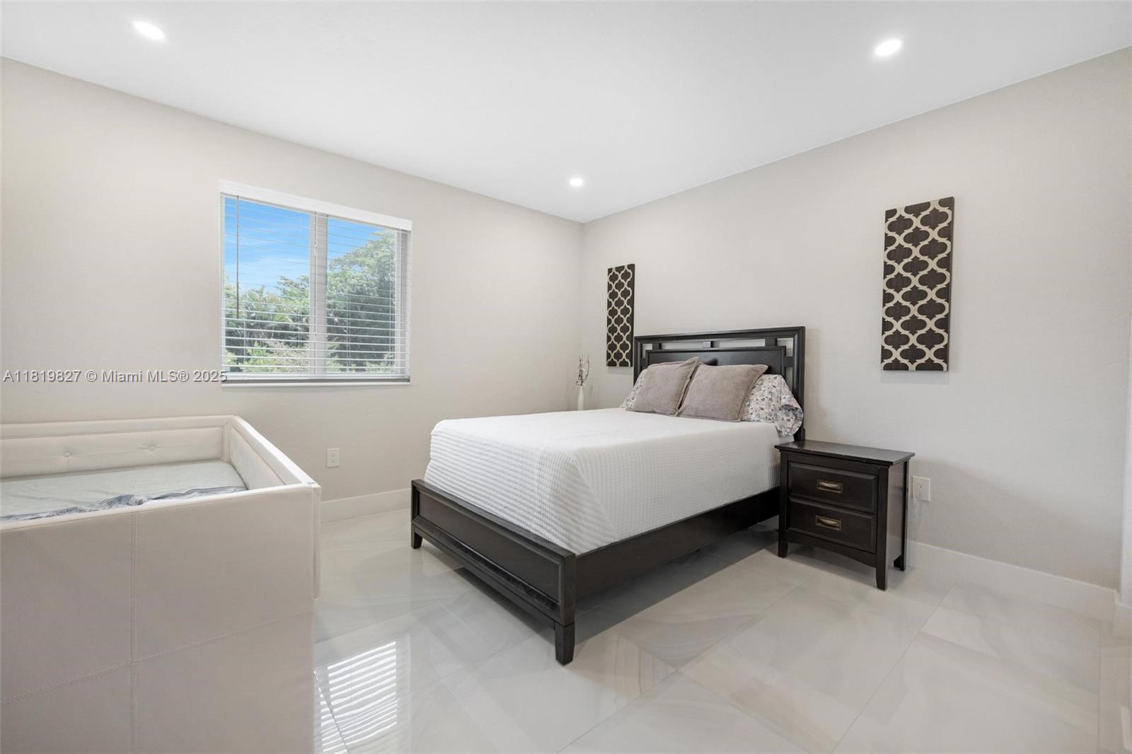 12851 Luray Road Southwest Ranches, FL 33330 - Photo 35 of 58 a bedroom with a bed and a window