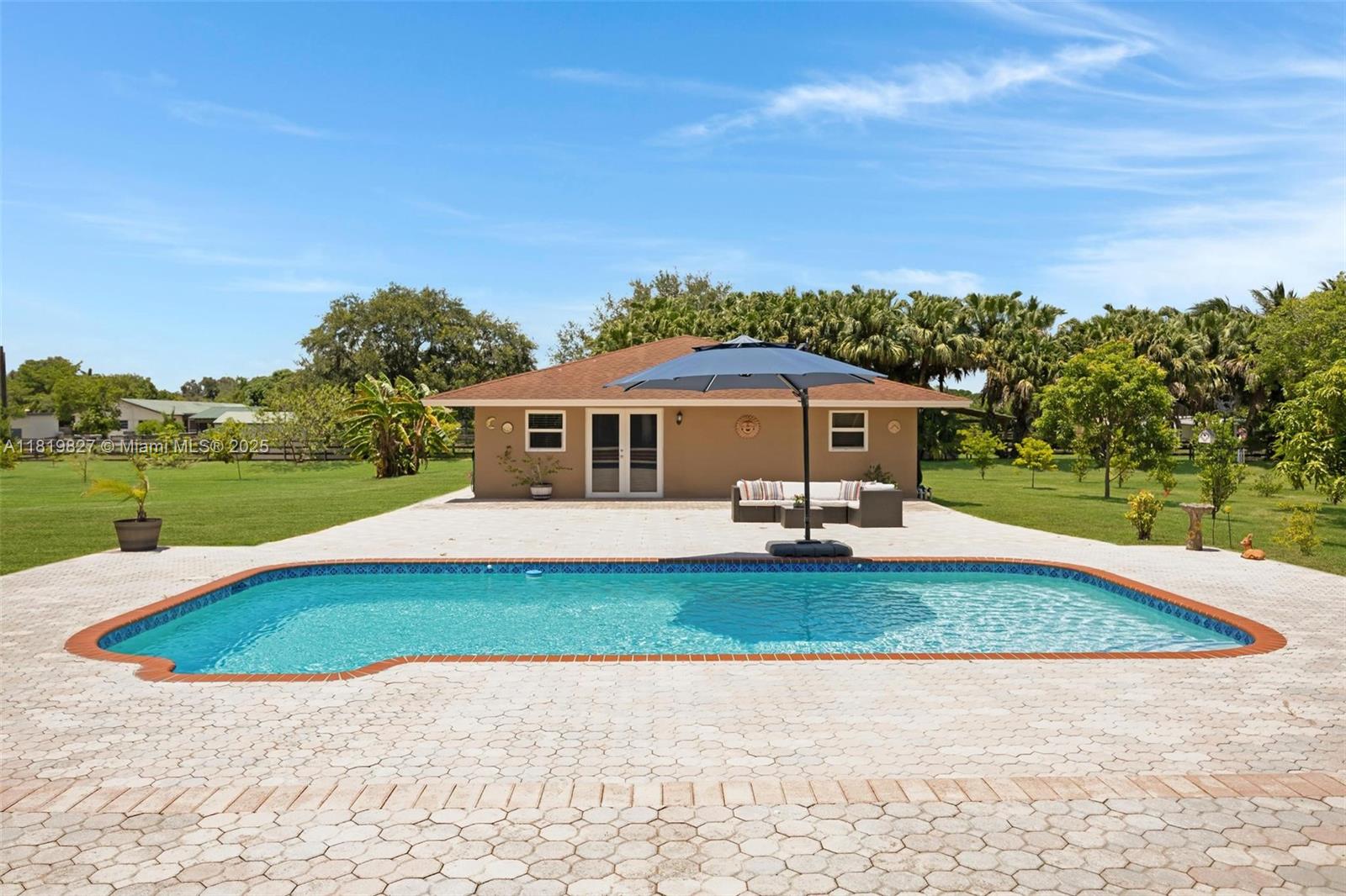 12851 Luray Road Southwest Ranches, FL 33330 - Photo 45 of 58 a front view of a house with a yard