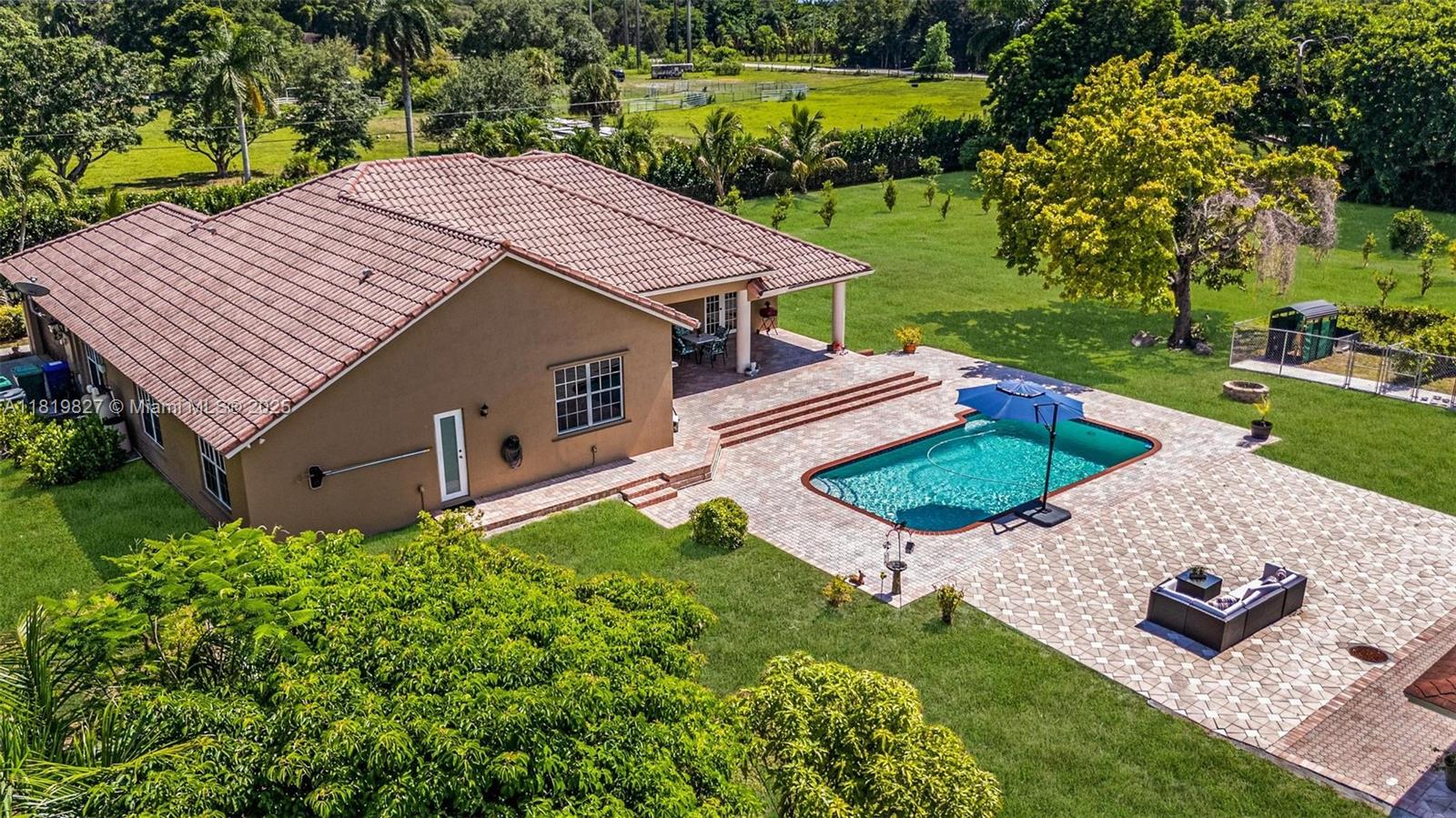 12851 Luray Road Southwest Ranches, FL 33330 - Photo 47 of 58 an aerial view of a house with swimming pool garden and patio