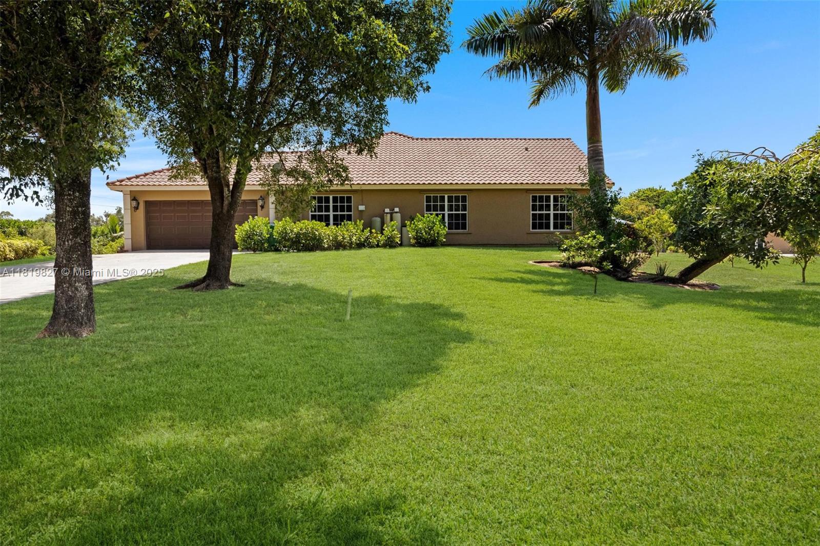 12851 Luray Road Southwest Ranches, FL 33330 - Photo 53 of 58 a front view of a house with garden