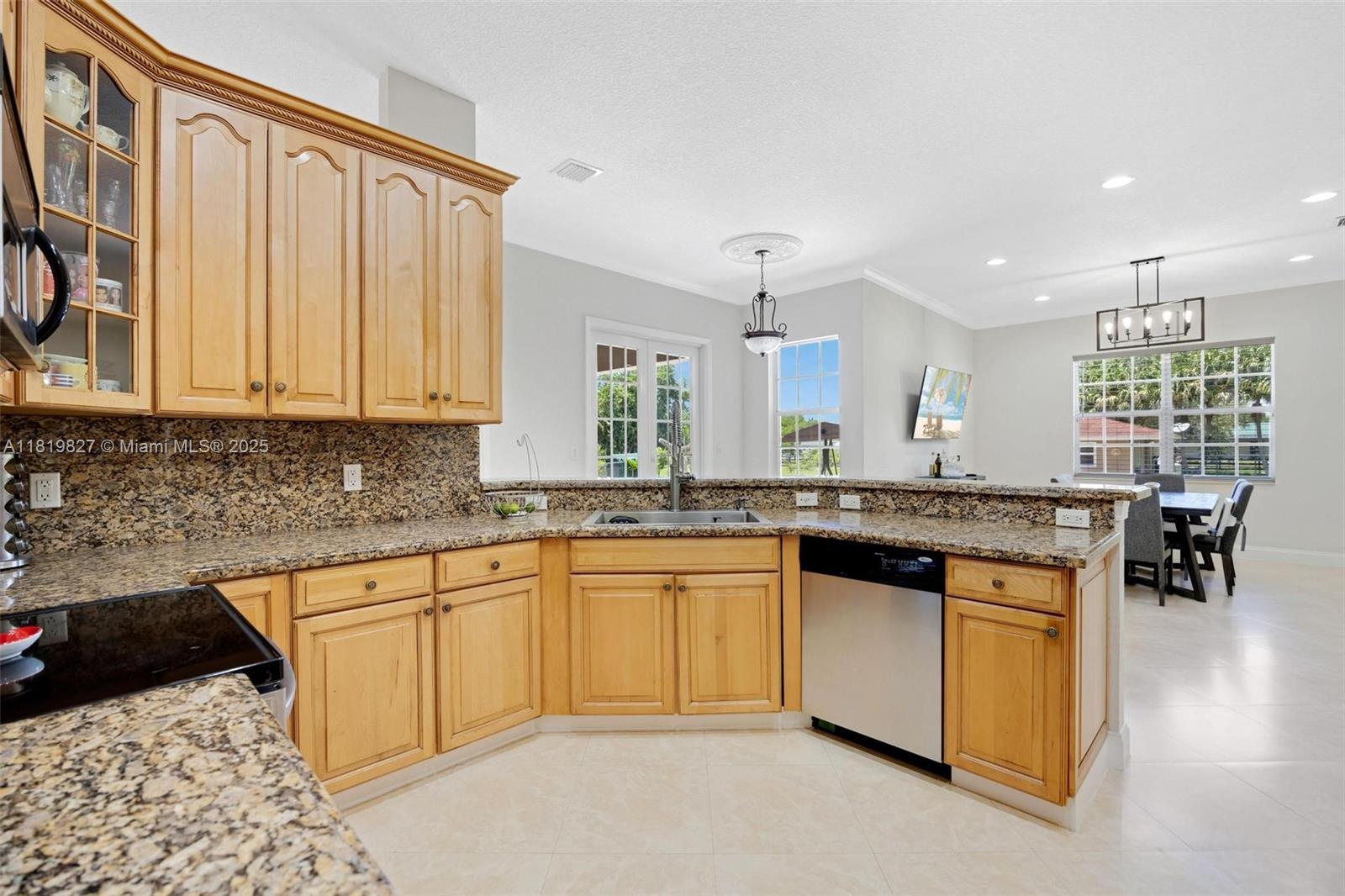 12851 Luray Road Southwest Ranches, FL 33330 - Photo 8 of 58 a kitchen with stainless steel appliances granite countertop a stove a sink and a microwave