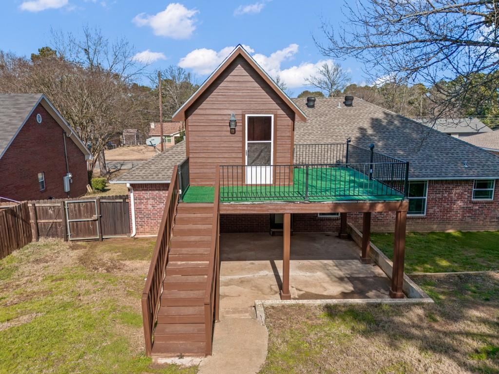 804 Alta Street Longview, TX 75604 - Photo 18 of 20 a view of house with backyard and trees