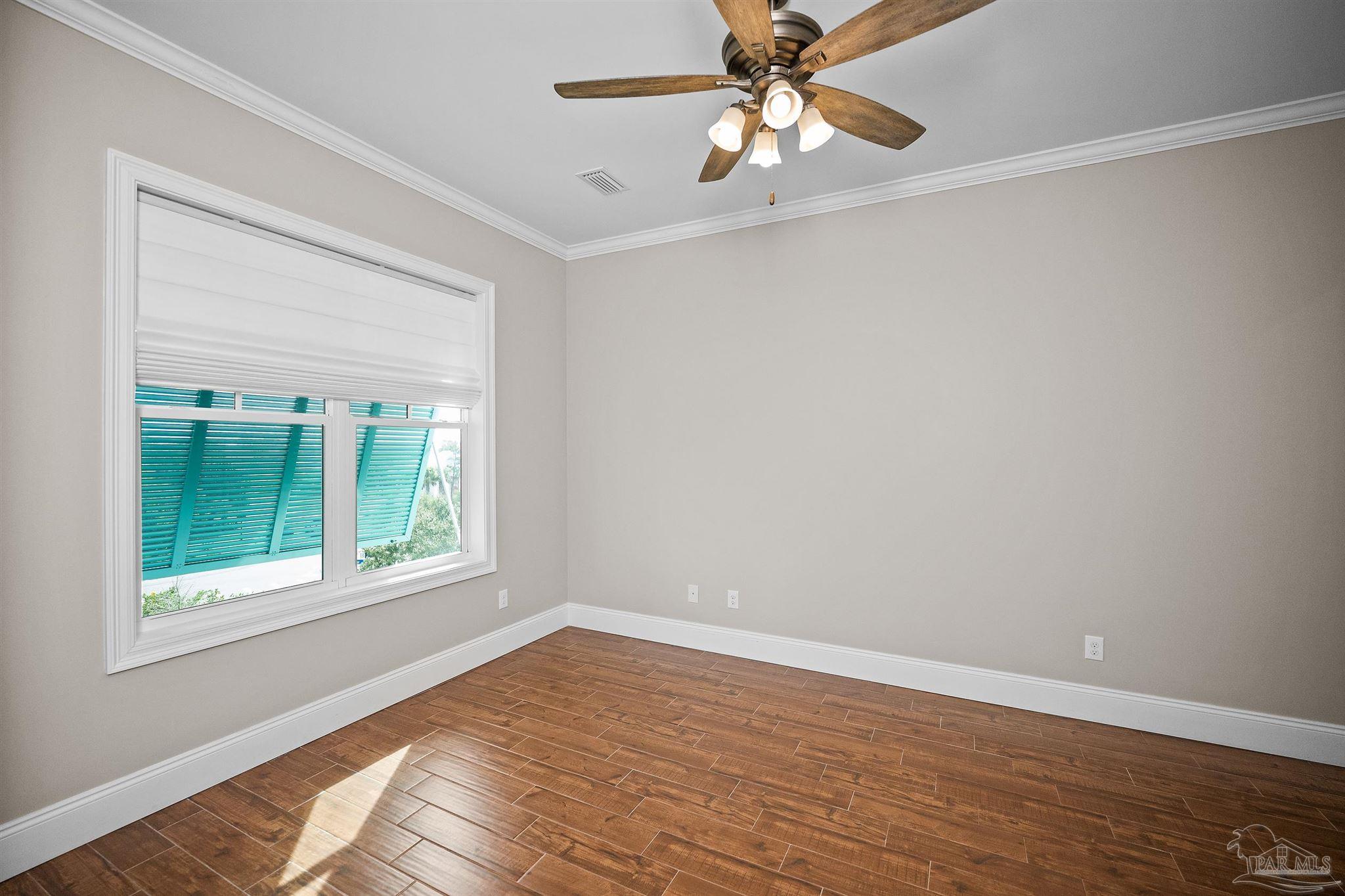 31729 River Road Orange Beach, AL 36561 - Photo 14 of 57 a view of an empty room with window and wooden floor