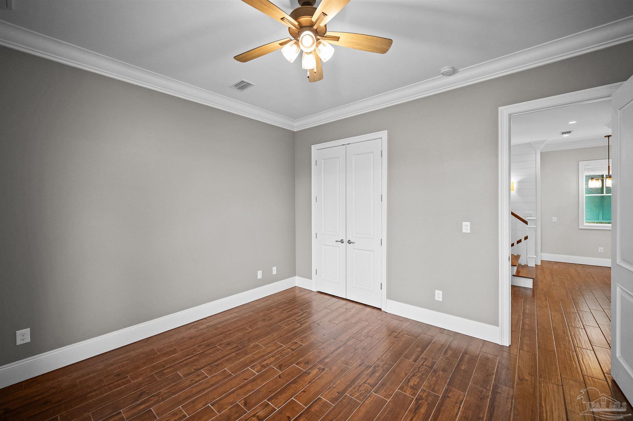 31729 River Road Orange Beach, AL 36561 - Photo 24 of 57 a view of a room with wooden floor and a ceiling fan
