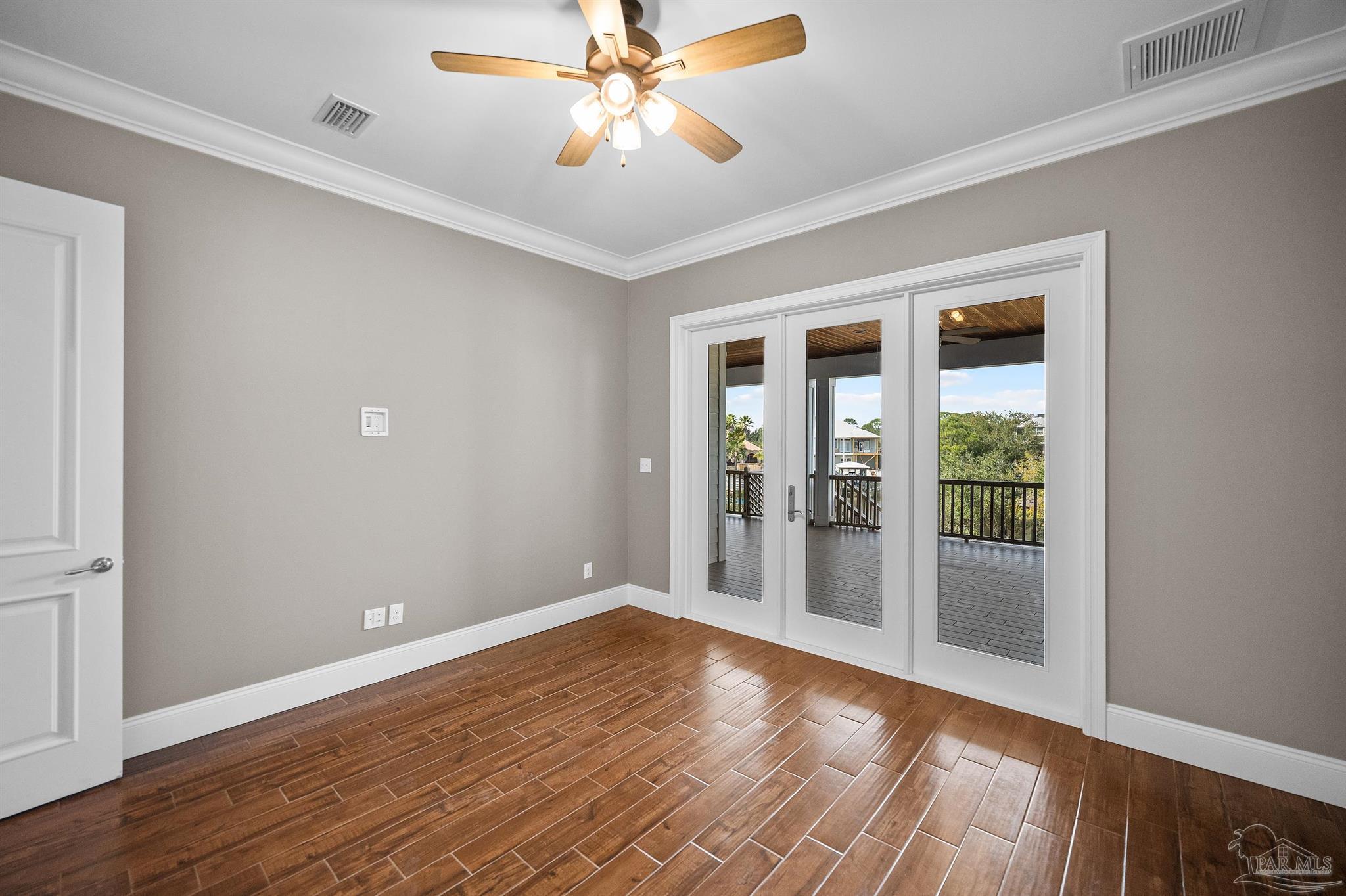 31729 River Road Orange Beach, AL 36561 - Photo 25 of 57 wooden floor in an empty room with a window