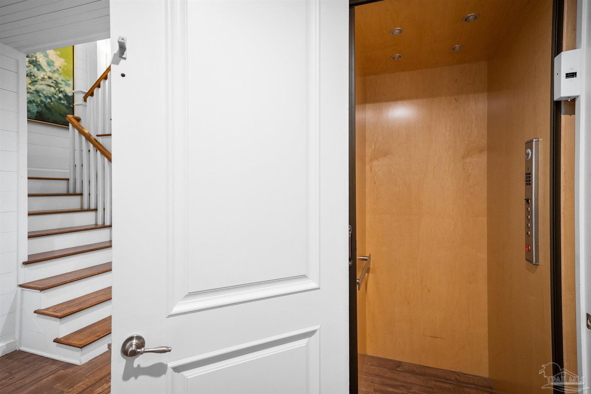 31729 River Road Orange Beach, AL 36561 - Photo 38 of 57 a view of a hallway with wooden floor and stairs