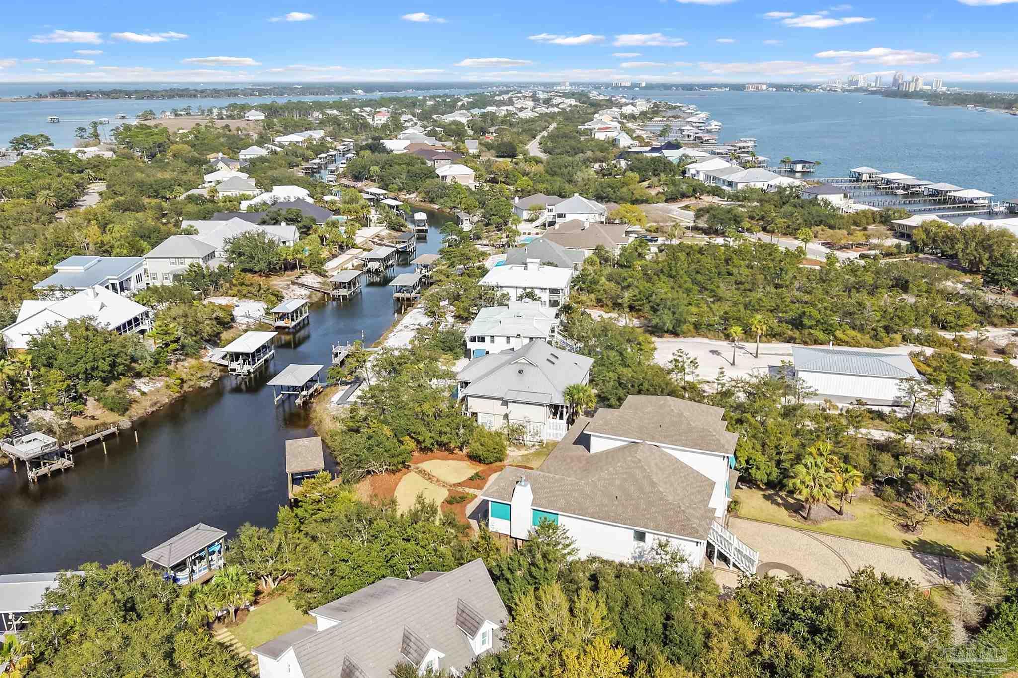 31729 River Road Orange Beach, AL 36561 - Photo 55 of 57 an aerial view of a city with lots of residential buildings ocean and mountain view in back