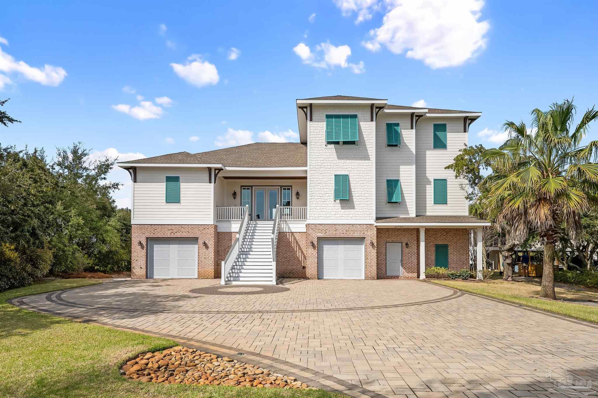 31729 River Road Orange Beach, AL 36561 - Photo 57 of 57 a front view of a house with a yard and garage