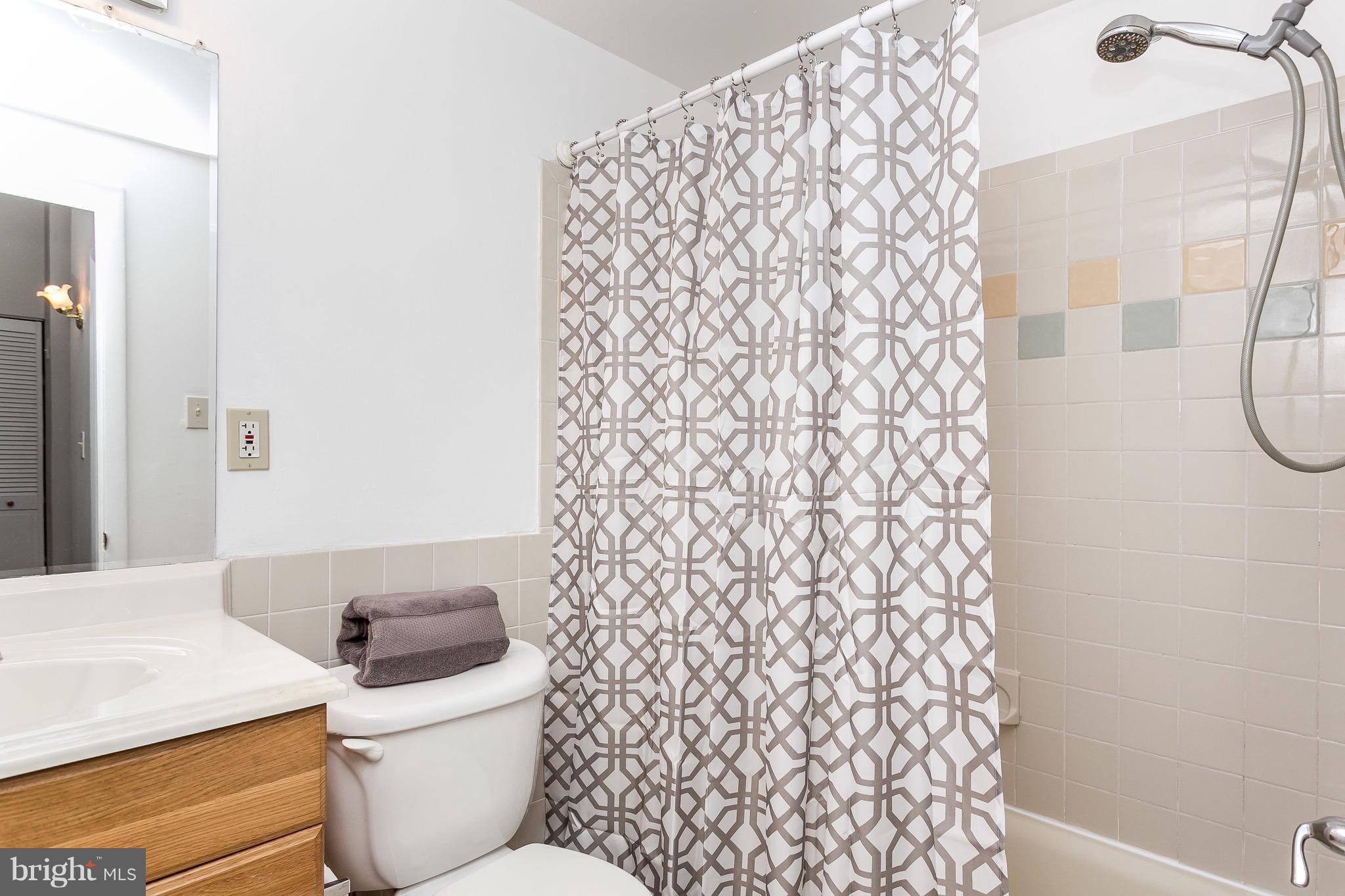 9408 Merryrest Road Columbia, MD 21045 - Photo 15 of 30 a bathroom with a toilet and a shower curtain