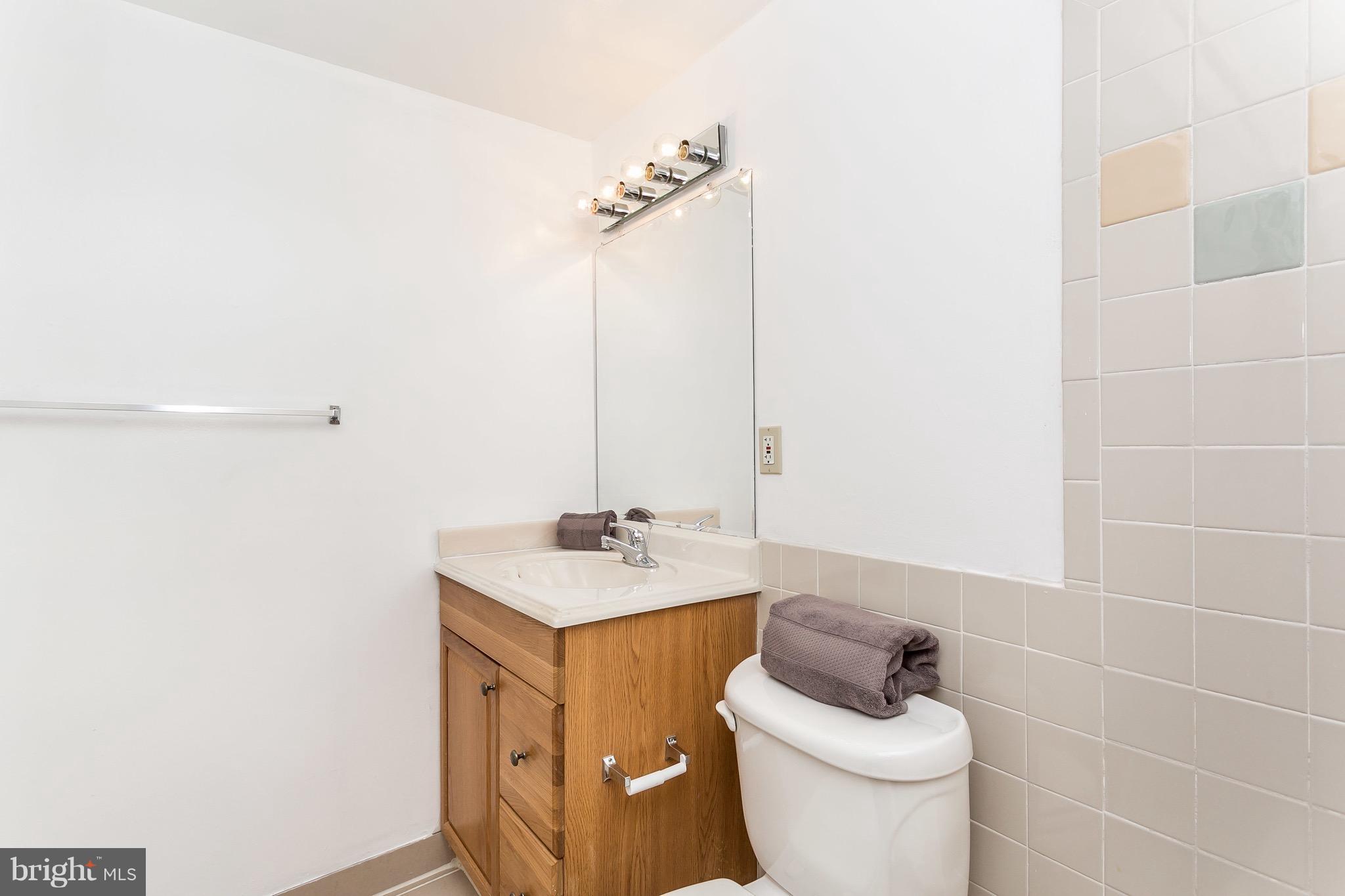 9408 Merryrest Road Columbia, MD 21045 - Photo 16 of 30 a bathroom with a sink a toilet and a mirror