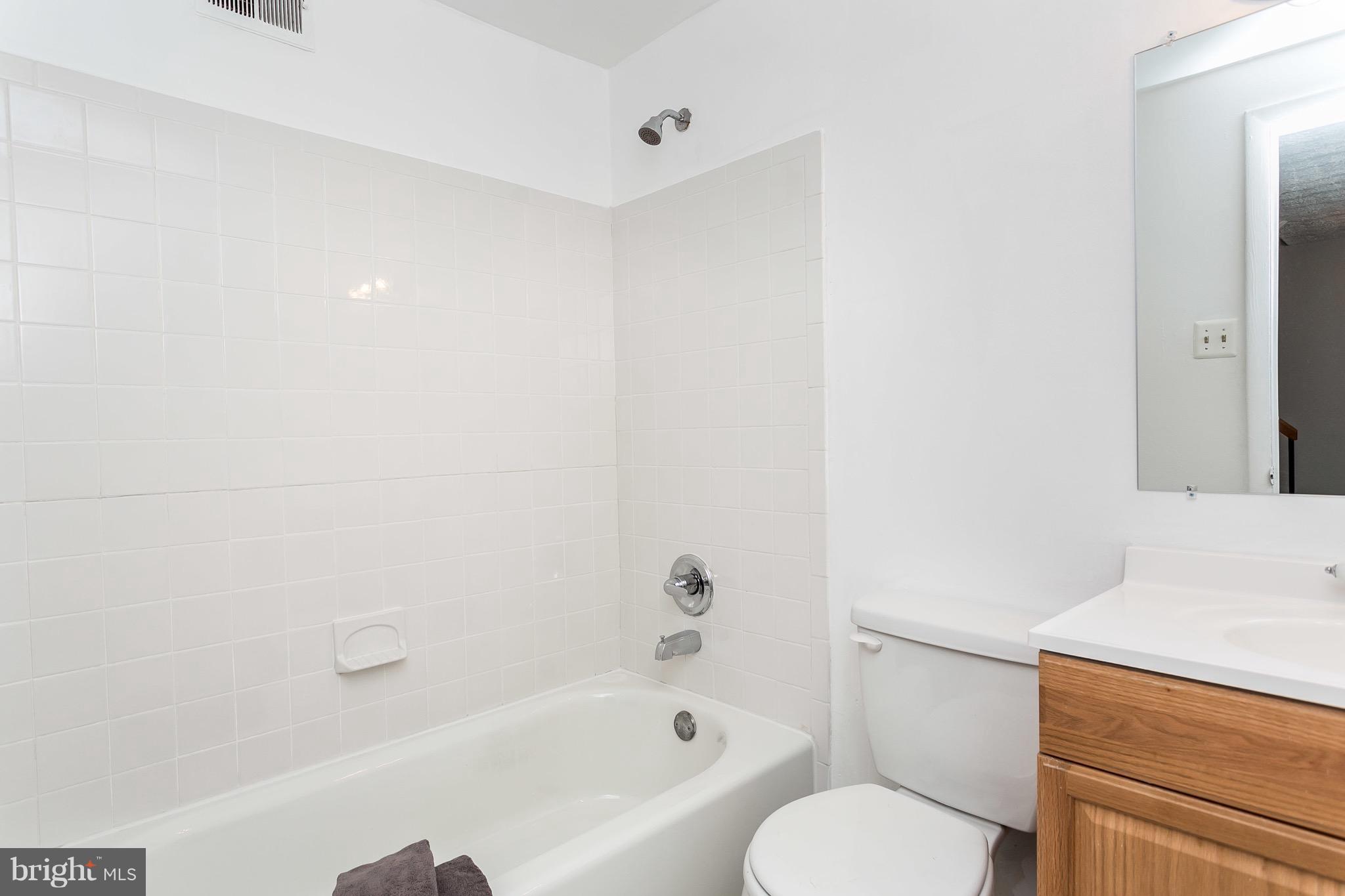 9408 Merryrest Road Columbia, MD 21045 - Photo 24 of 30 a bathroom with a bathtub shower sink vanity and toilet