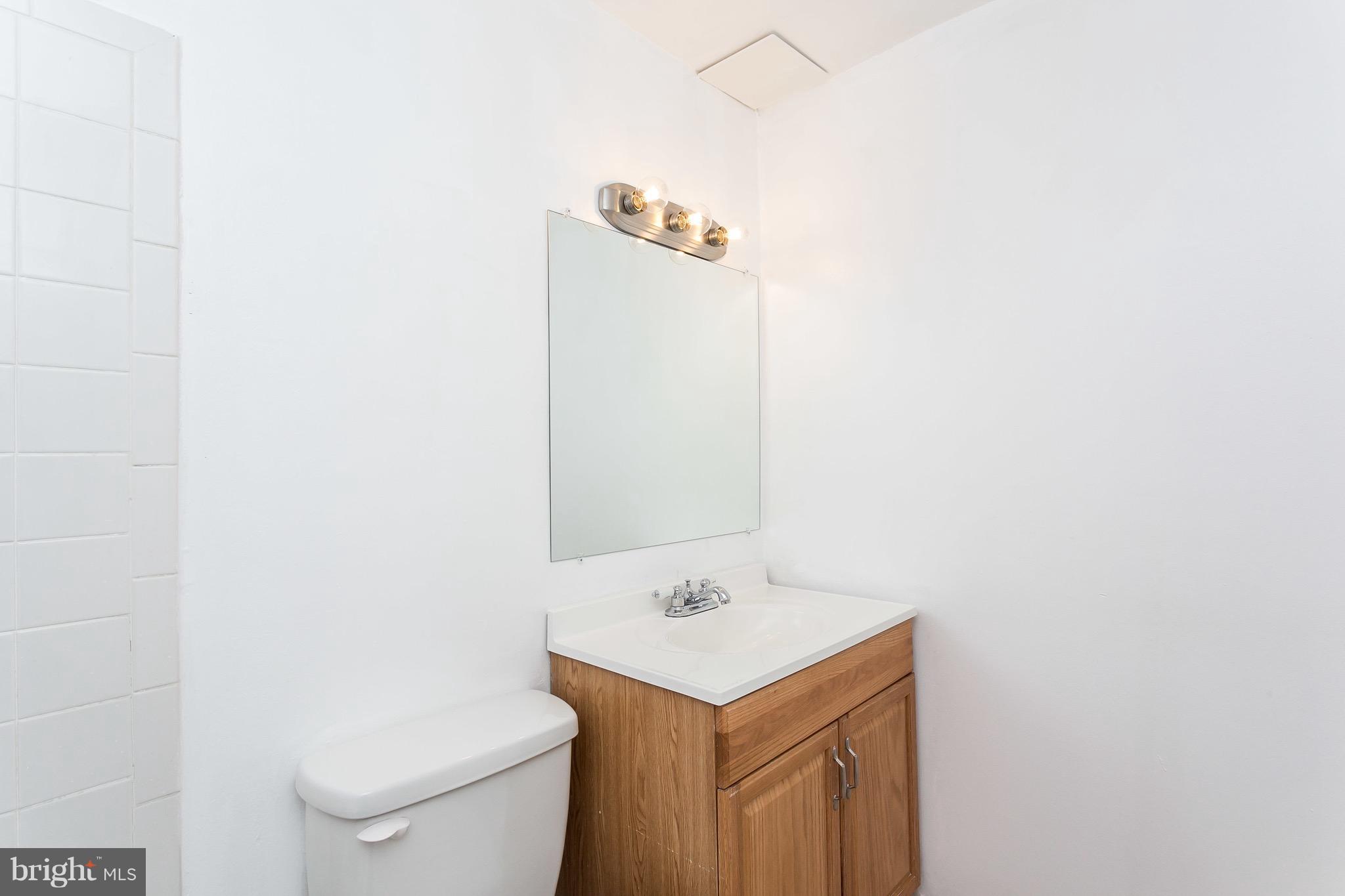 9408 Merryrest Road Columbia, MD 21045 - Photo 25 of 30 a bathroom with a sink a toilet and mirror