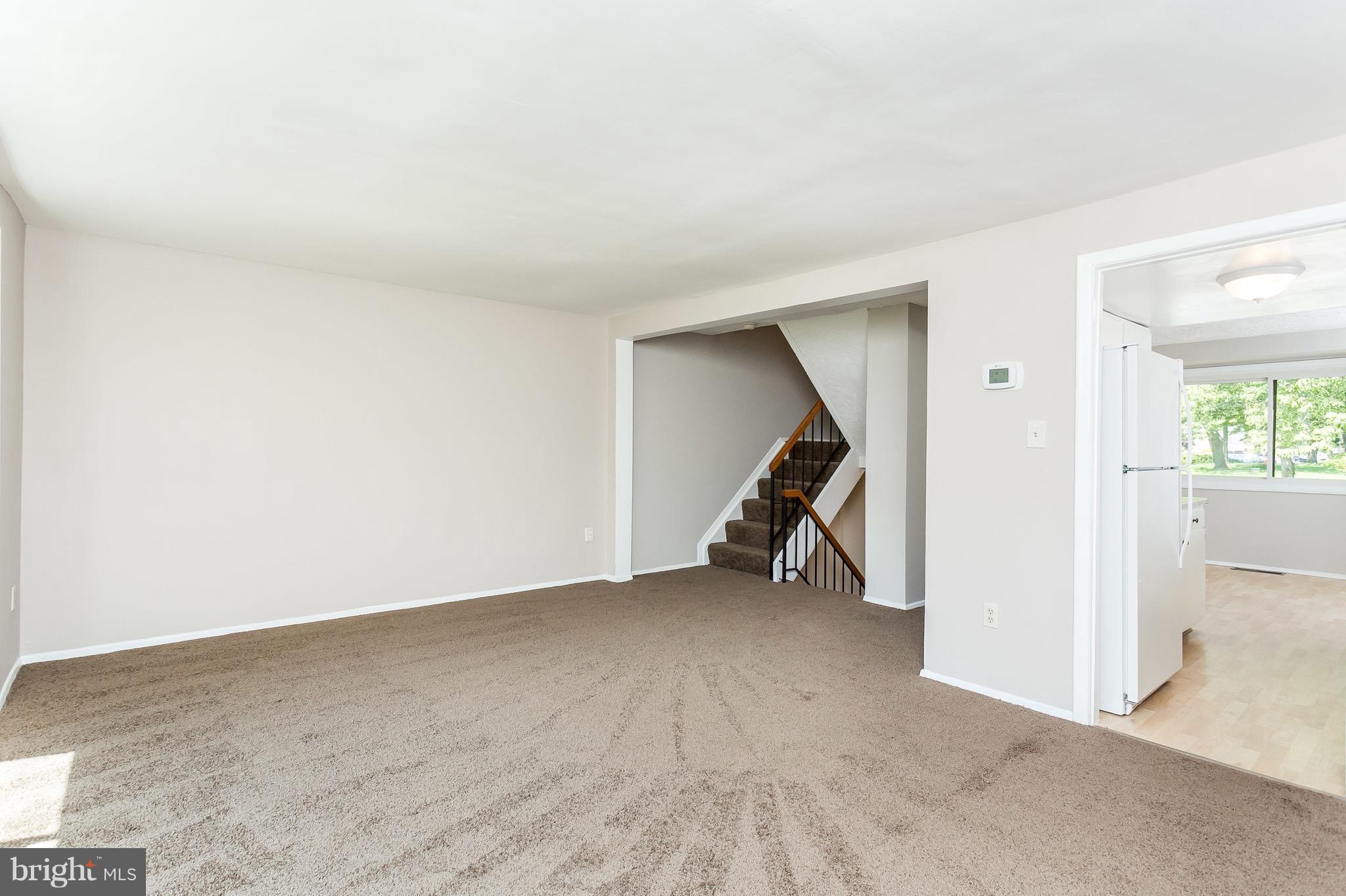 9408 Merryrest Road Columbia, MD 21045 - Photo 4 of 30 an empty room with a fireplace and a fan