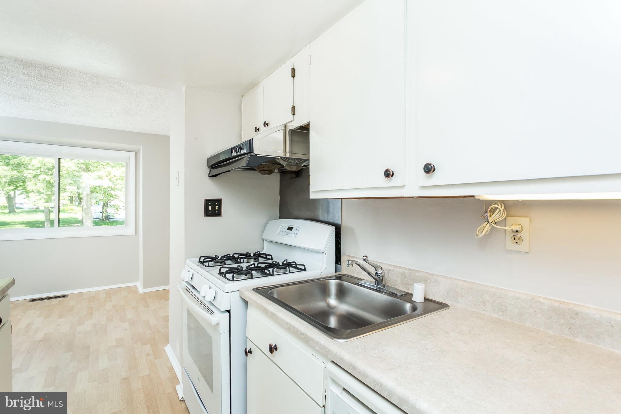 9408 Merryrest Road Columbia, MD 21045 - Photo 6 of 30 a kitchen with stainless steel appliances granite countertop a sink stove and cabinets